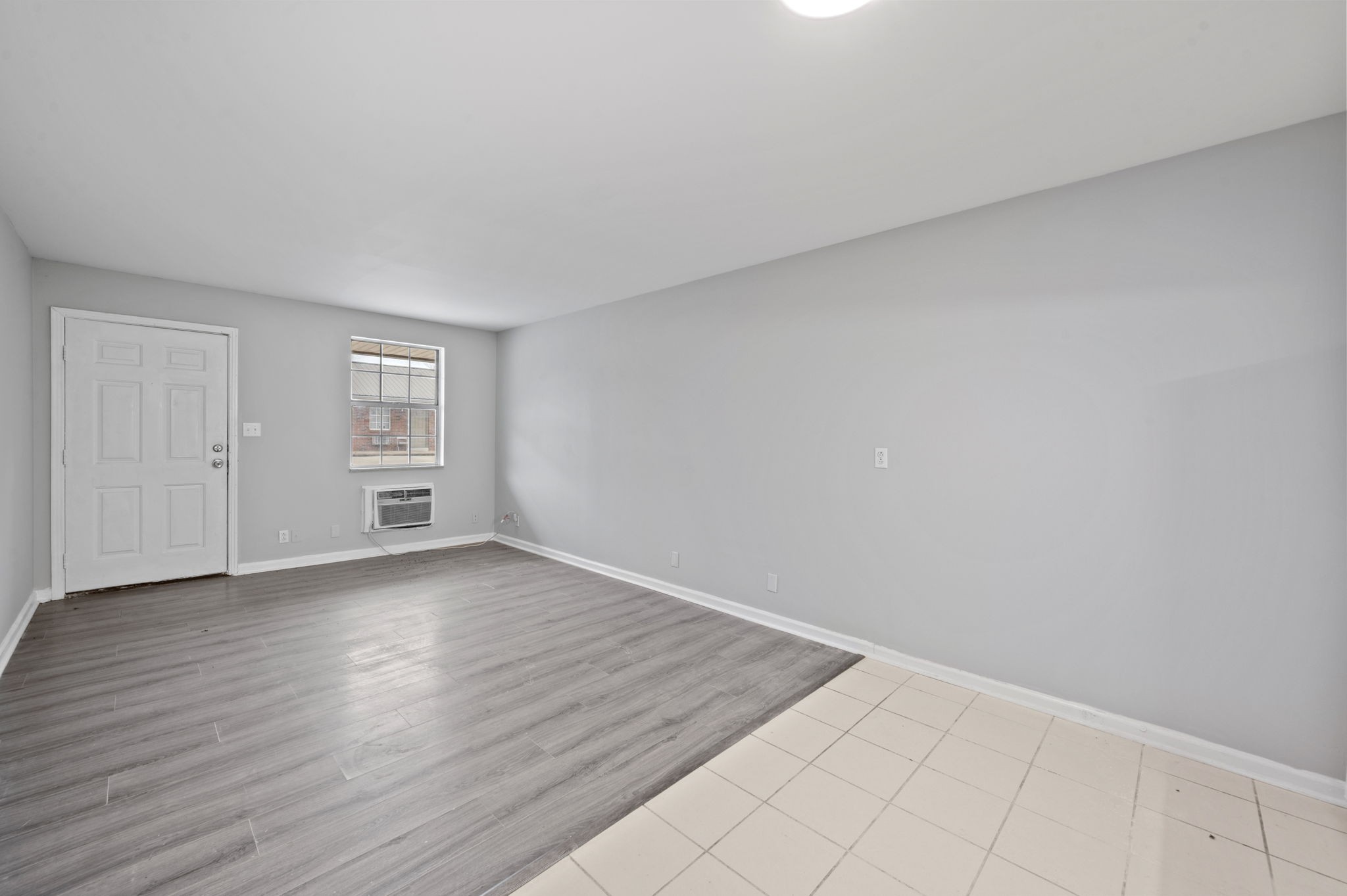 101 Walnut Street, Unit 19 Clarksville, TN 37042 - Photo 7 of 12 a view of an empty room with a window and wooden floor