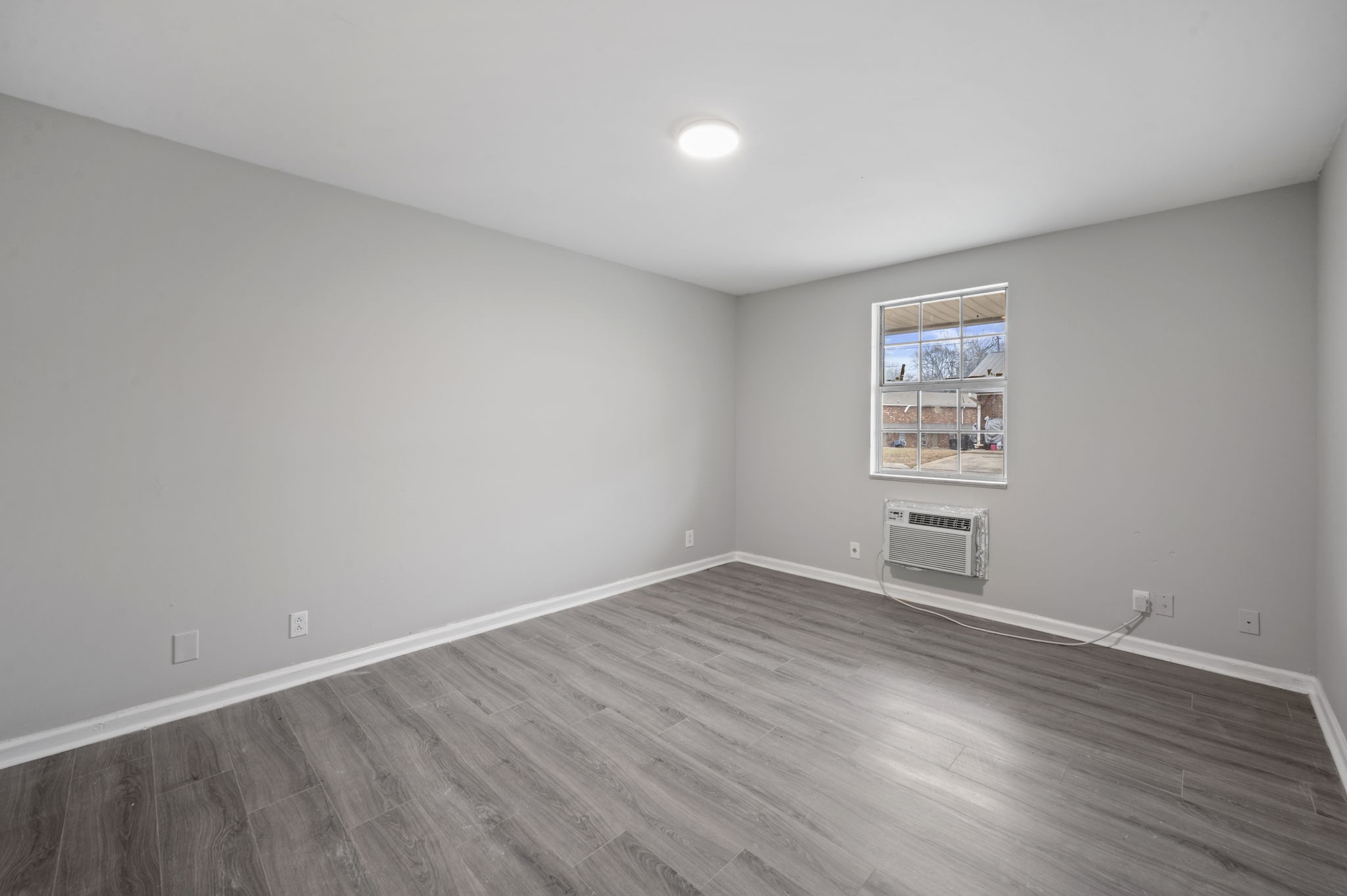 101 Walnut Street, Unit 19 Clarksville, TN 37042 - Photo 9 of 12 an empty room with wooden floor and windows
