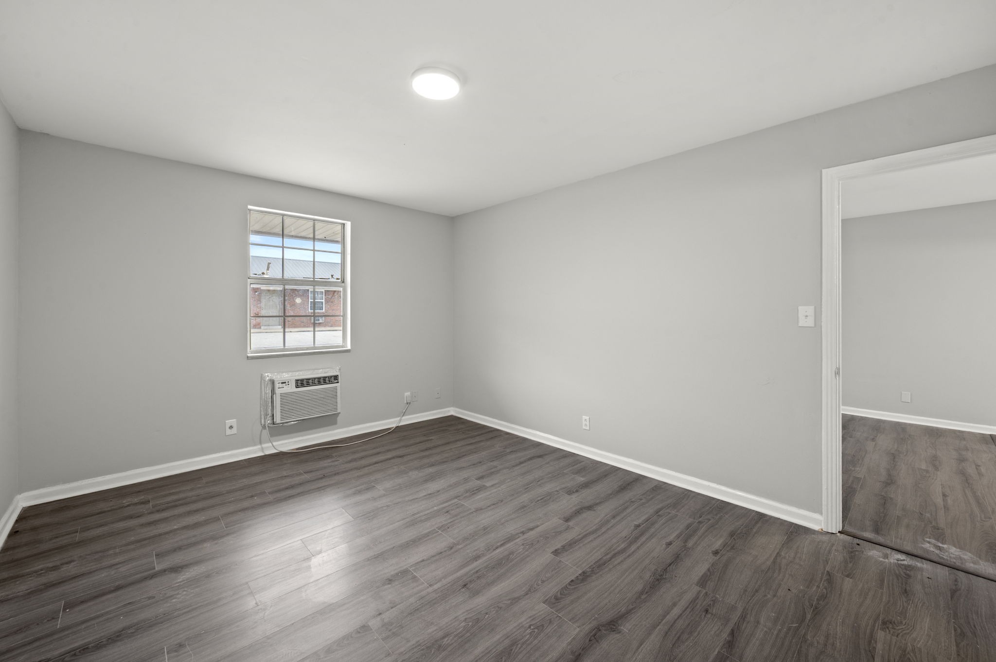 101 Walnut Street, Unit 19 Clarksville, TN 37042 - Photo 10 of 12 an empty room with wooden floor and windows