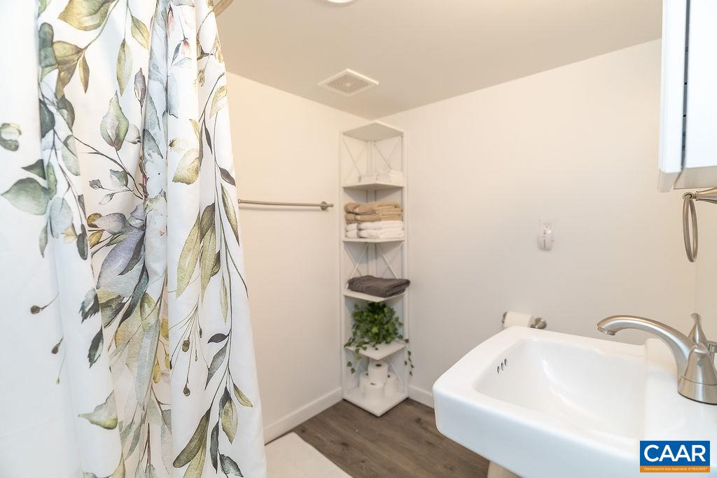 6920 Albevanna Spring Road Scottsville, VA 24590 - Photo 38 of 47 a bathroom with a sink and mirror with bathtub