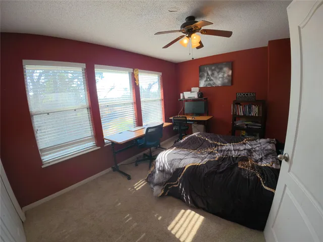 a bed sitting in a bedroom next to a window