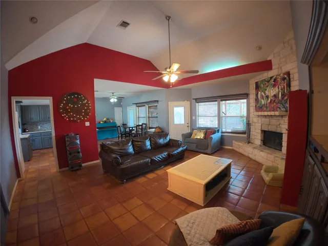 a living room with furniture a fireplace and a flat screen tv
