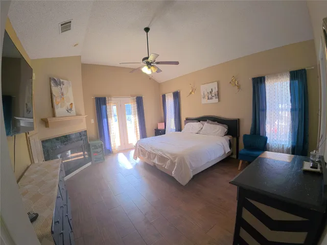 a bedroom with a bed window and a flat screen tv