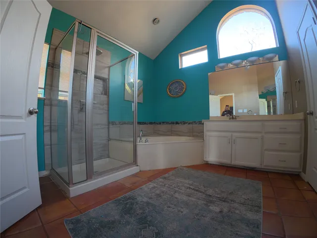 a spacious bathroom with a mirror a sink and a mirror