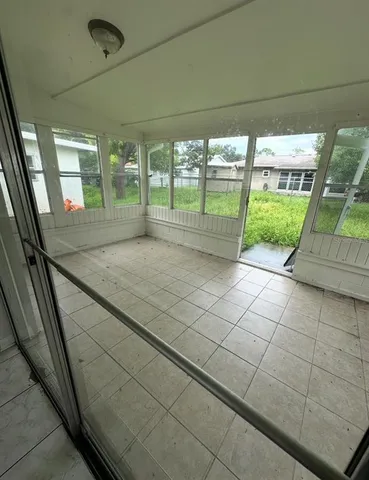 a view of empty room with floor to ceiling window and an outdoor view