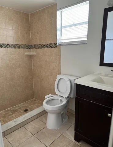 a bathroom with a sink toilet a mirror and shower