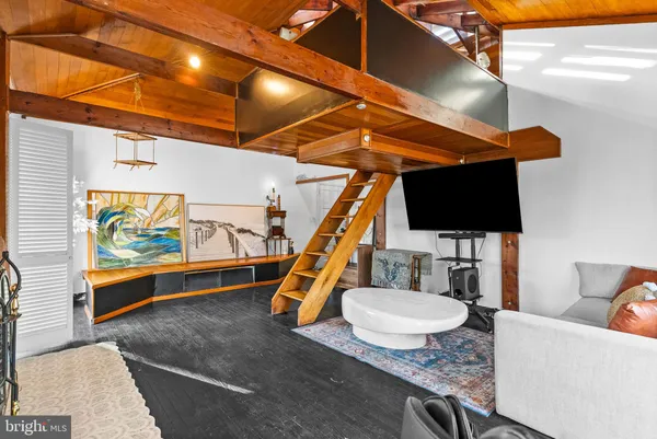 a work room with furniture and a flat screen tv