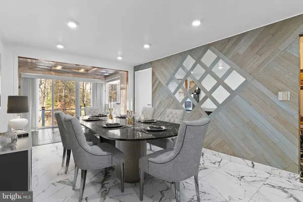a dining room with furniture and wooden floor