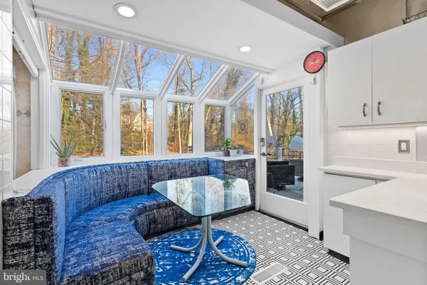 a view of a livingroom with a kitchen stove and floor to ceiling window
