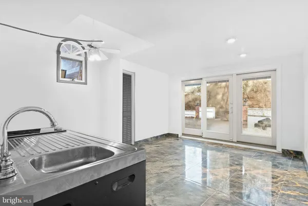 a view of a kitchen with a sink and a window