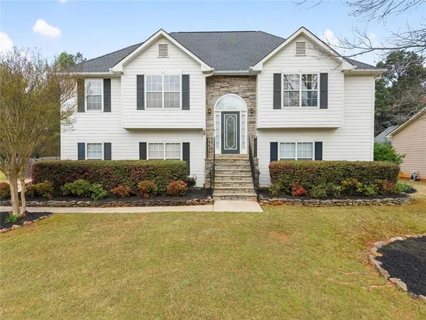 a front view of a house with a yard