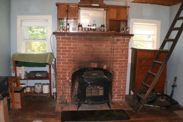 9 Athens Avenue Rutland, MA 01543 - Photo 4 of 21 a living room with a fireplace a window and potted plant