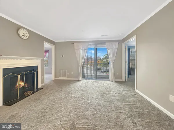 a view of empty room with window and fireplace