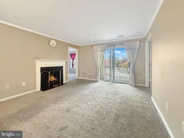 an empty room with fireplace and fan