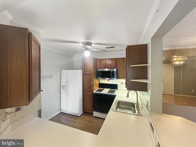 a very nice looking room with a large window and stainless steel appliances