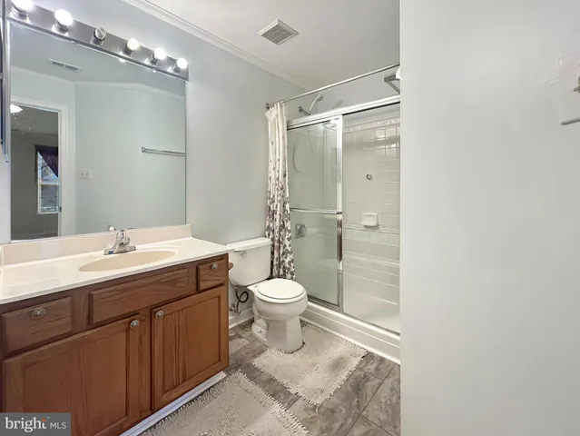 a bathroom with a double vanity sink toilet and shower