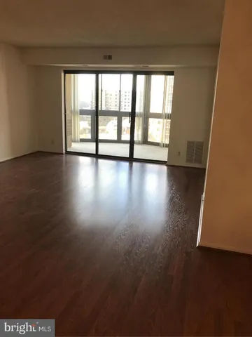 an empty room with wooden floor