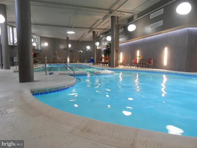 a swimming pool view with a outdoor seating