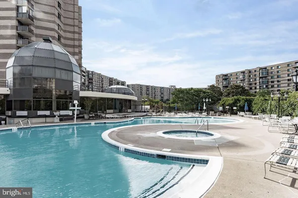 a swimming pool with outdoor seating and yard