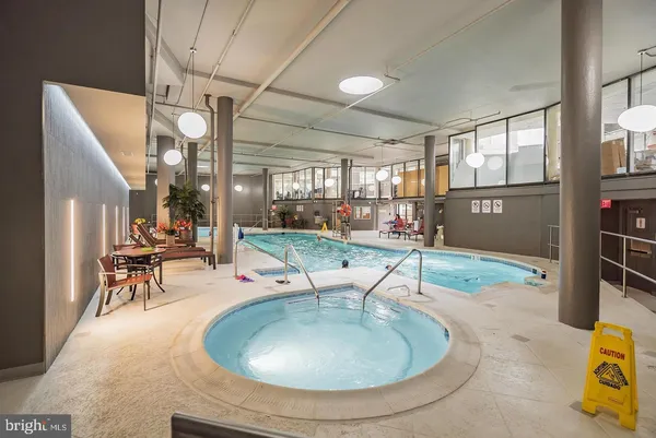 a swimming pool with outdoor seating and yard