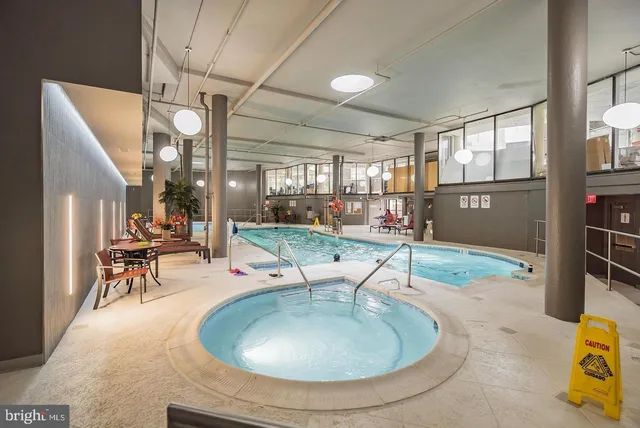 a swimming pool with outdoor seating and yard