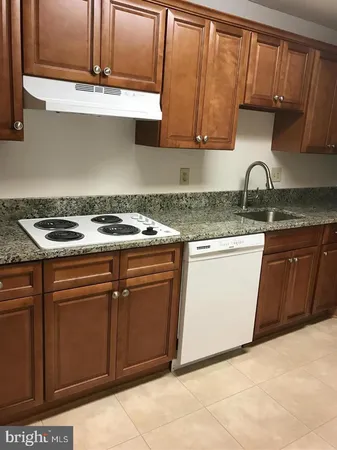 a stove top oven sitting inside of a kitchen