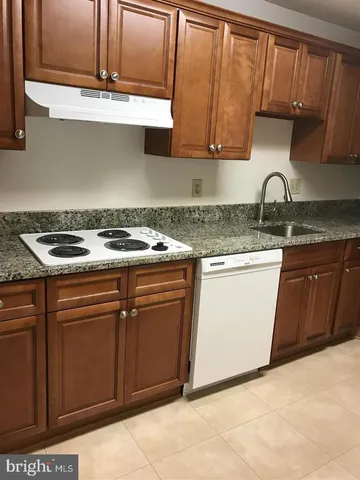 a stove top oven sitting inside of a kitchen