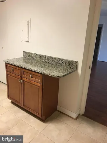 a kitchen with granite countertop cabinets stainless steel appliances and sink