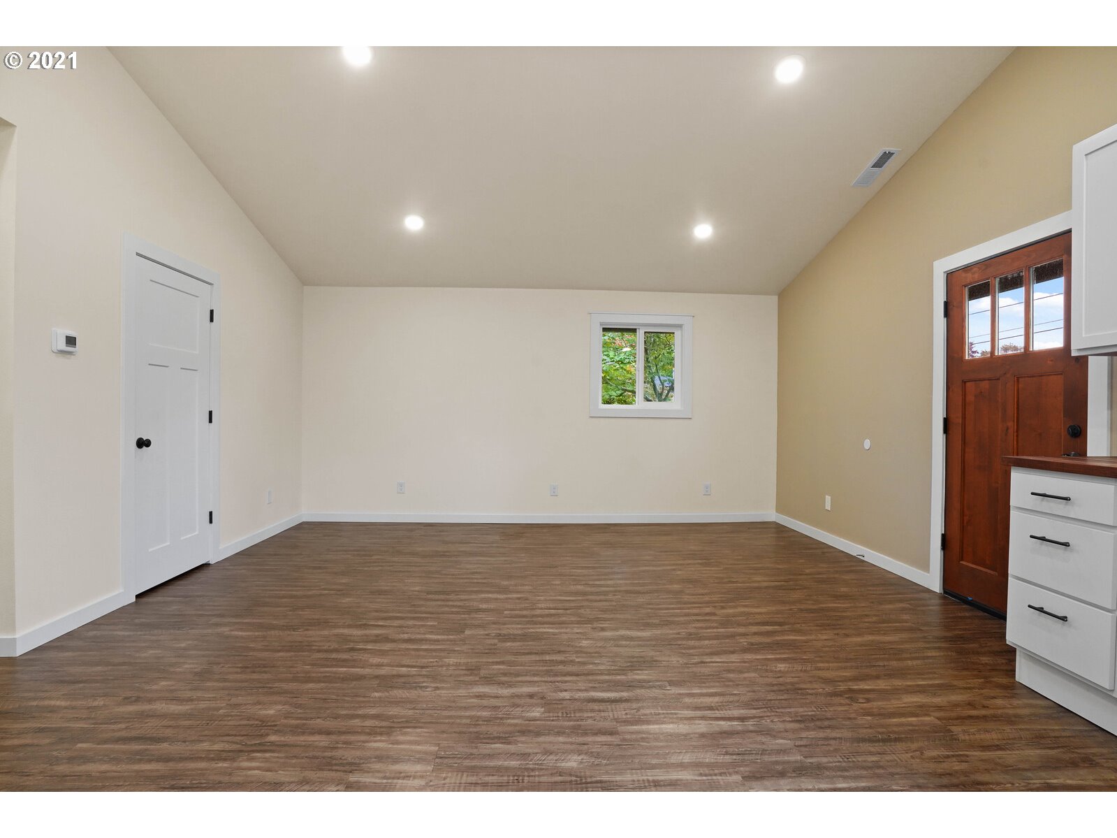 195 Mize Road Southeast Salem, OR 97302 - Photo 4 of 12 a view of an empty room with window and wooden floor
