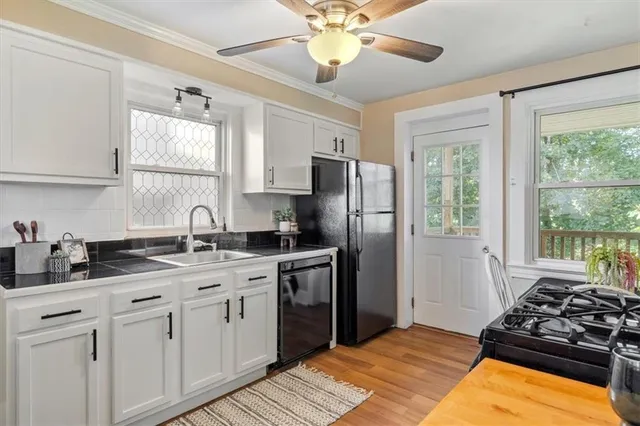 a kitchen with a sink stove and refrigerator