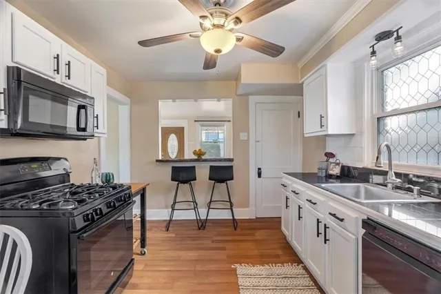 a kitchen with stainless steel appliances granite countertop a stove cabinets and a refrigerator
