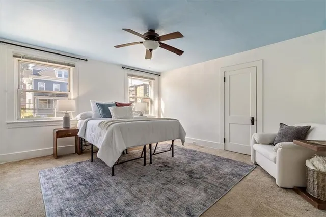 a bedroom with a bed and ceiling fan