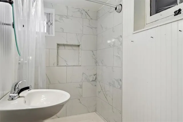 a bathroom with a bathtub and shower