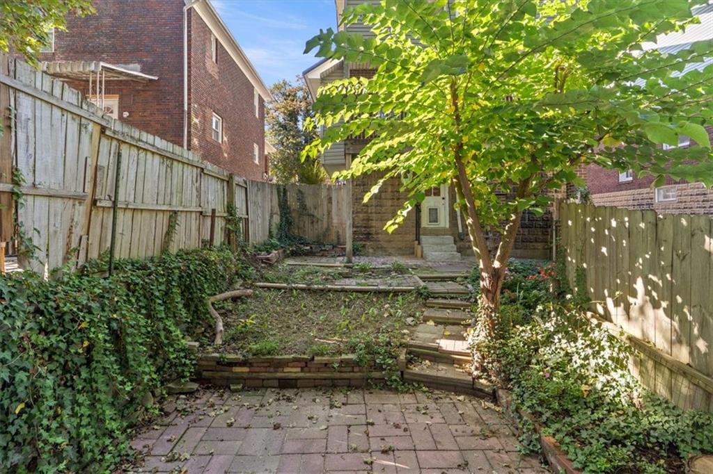 831 Malvern Road Pittsburgh, PA 15202 - Photo 26 of 33 a view of a yard with plants and large trees