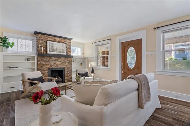 a living room with furniture fireplace and window