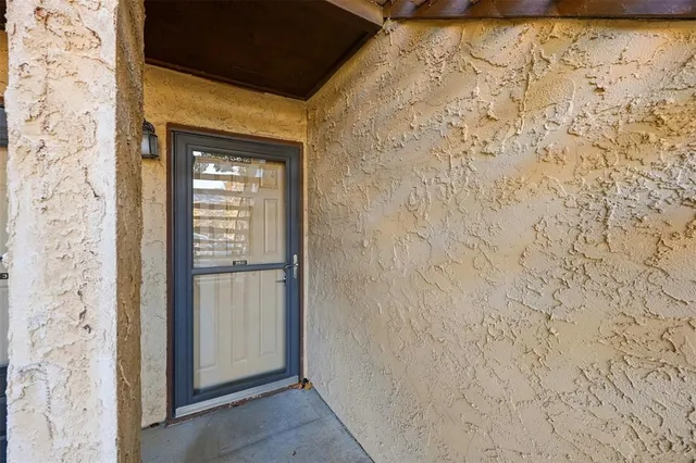 a view of a patio with a table and chairs