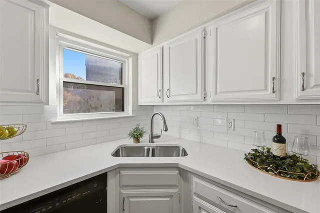 a kitchen with a sink and cabinets