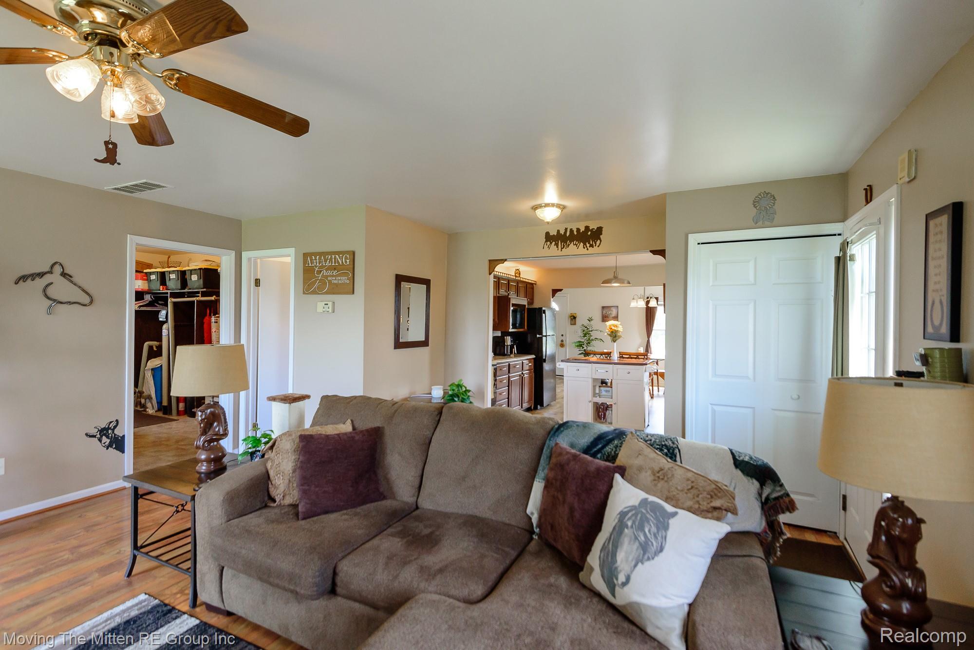 9260 Pitman Road Ypsilanti, MI 48197 - Photo 10 of 45 Living room featuring wood finished floors and a ceiling fan