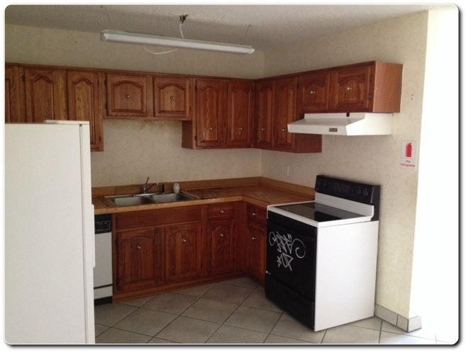 328 Shady Lane Road Palm Springs, FL 33461 - Photo 2 of 50 a kitchen with stainless steel appliances a stove a refrigerator and a sink with wooden cabinets