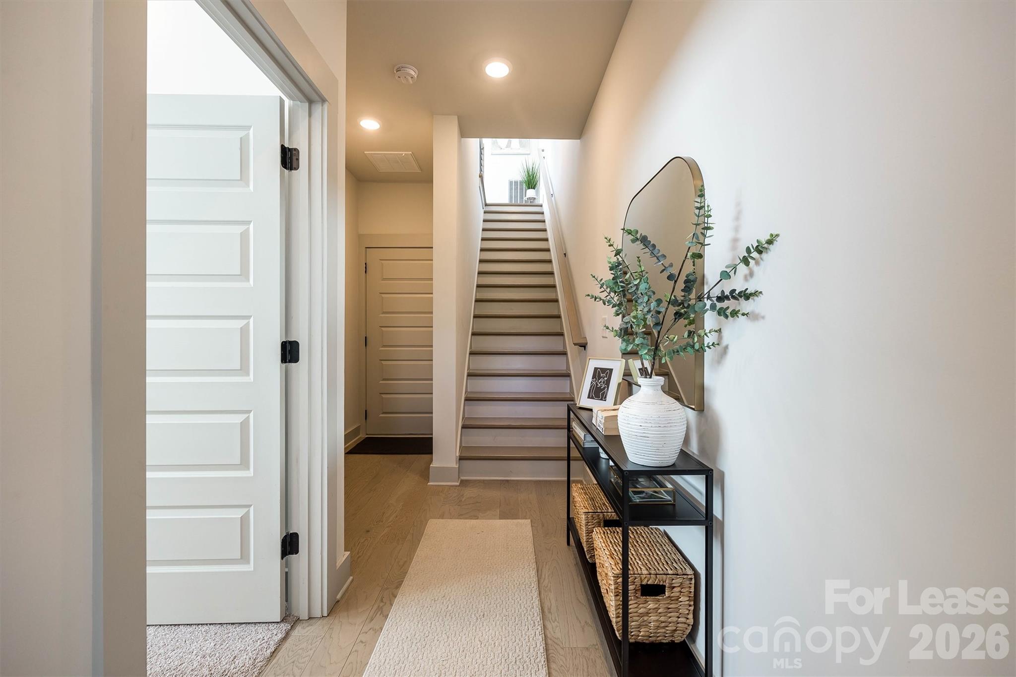 2319 Wesley Village Road Charlotte, NC 28208 - Photo 7 of 44 a hallway with white walls and stairs