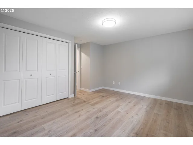 a view of an empty room and wooden floor
