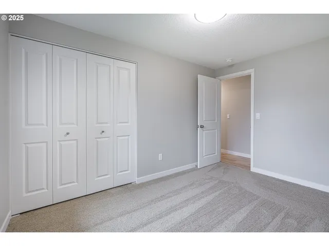 a view of an empty room with closet area