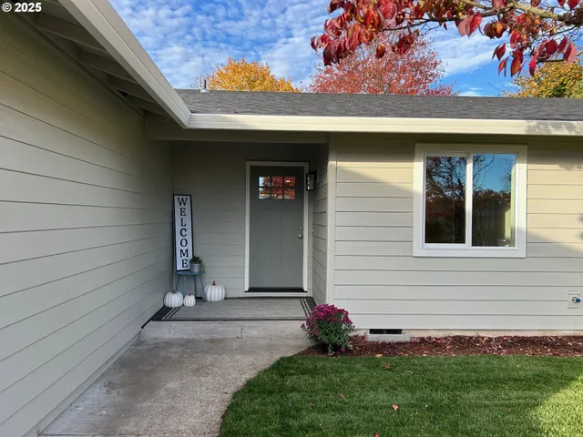 a front view of a house with a garden
