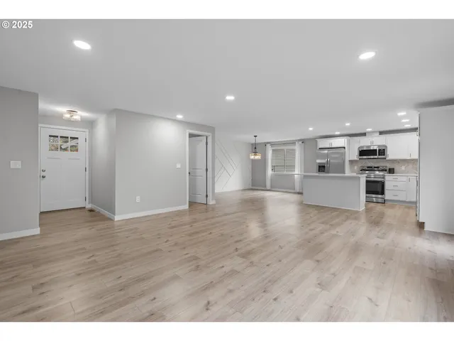 a view of a kitchen with a sink and a stove top oven