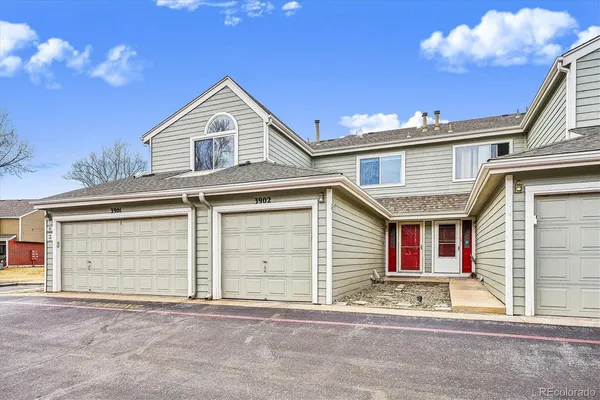 a view of a house with a garage and balcony