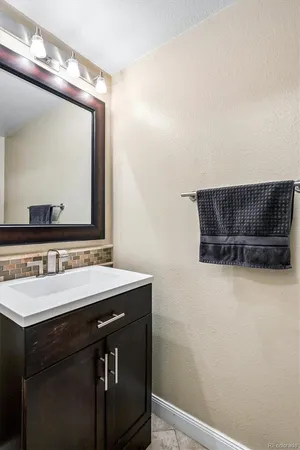 a bathroom with a sink a mirror and vanity