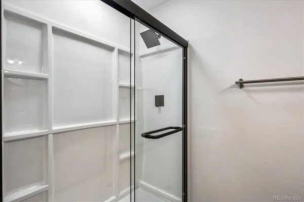 a bathroom with a glass shower door