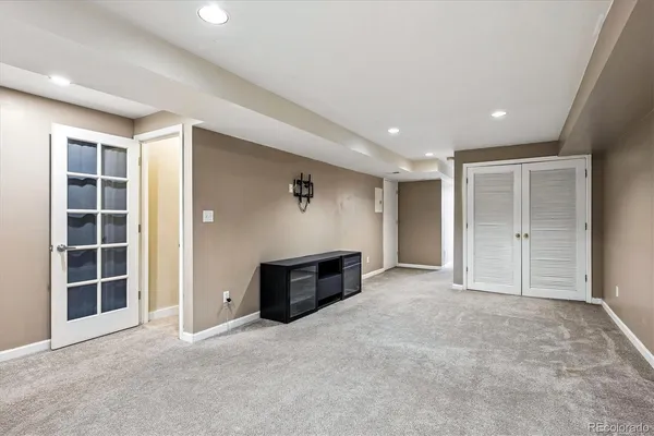 an empty room with a cabinet and mirrors