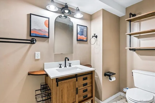 a bathroom with a sink toilet and mirror