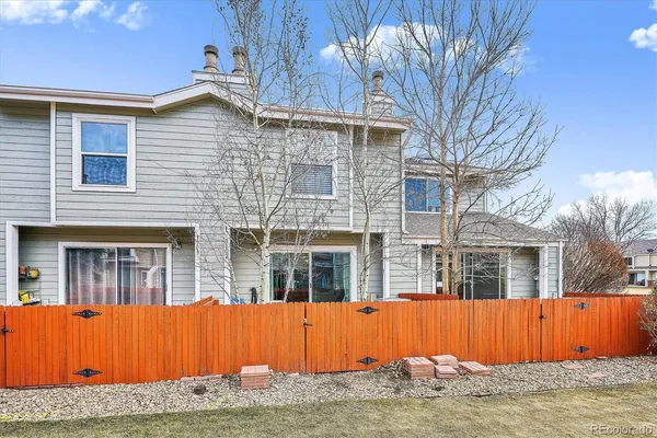 a view of a house with a tub and wooden fence